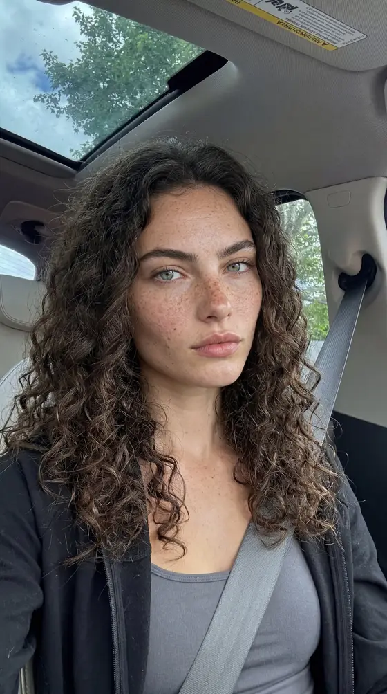 The same character, car interior with the seatbelt on