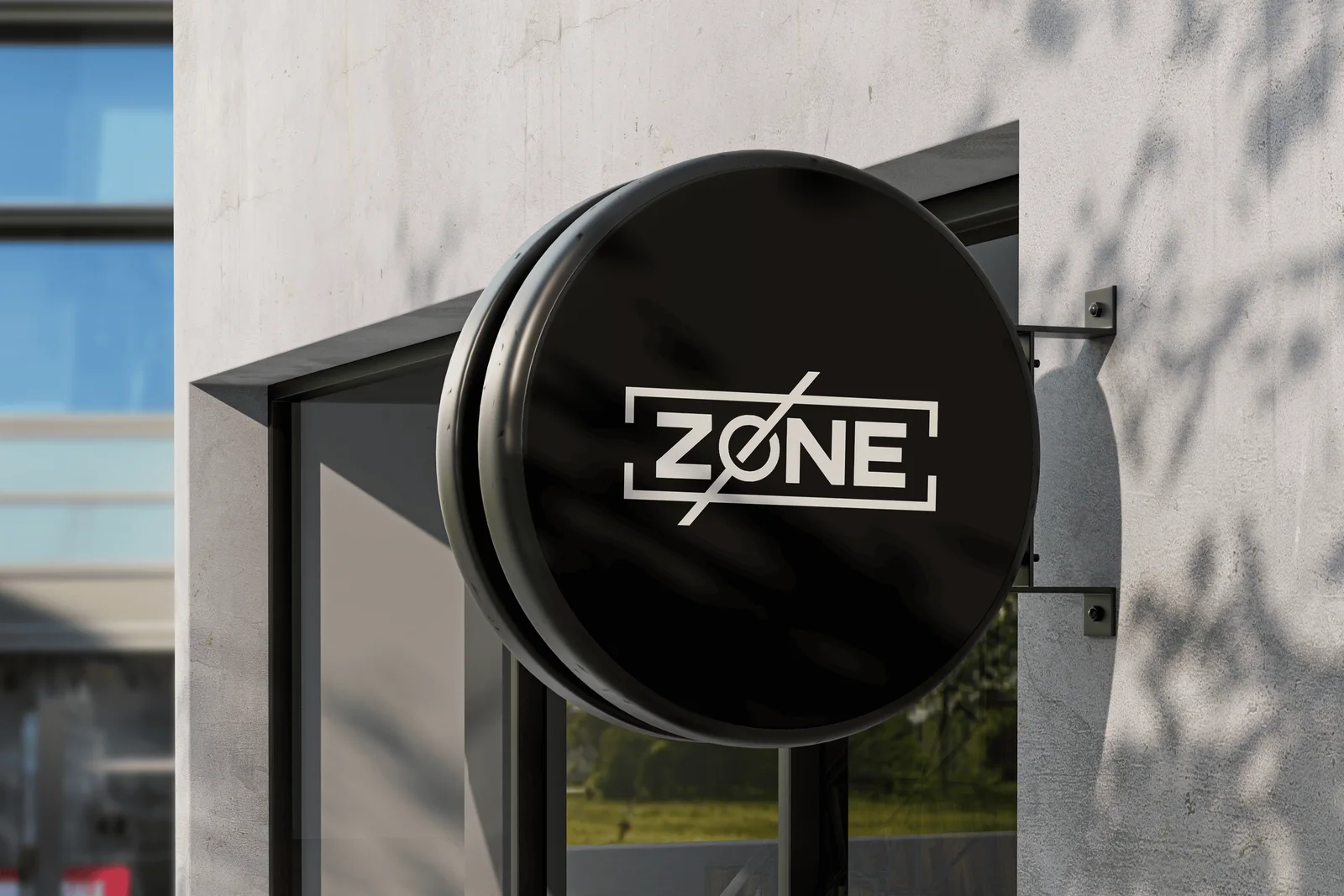 Zone wordmark in white on a circular black sign mounted to a concrete facade